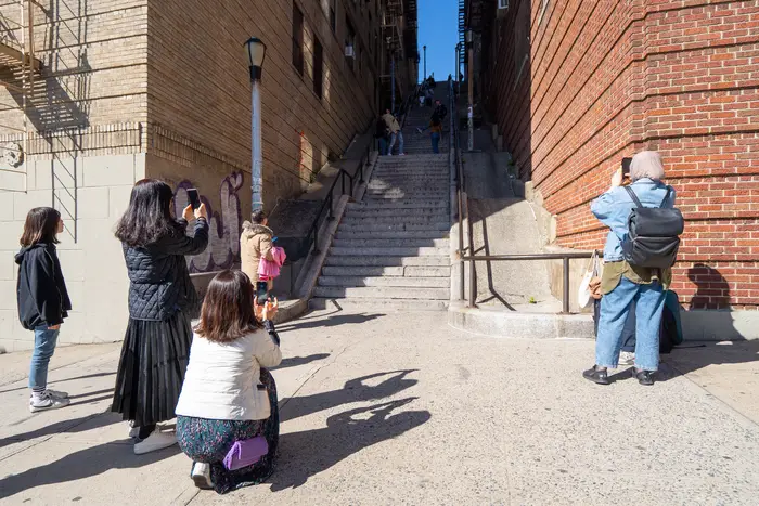 Tourists and sightseers take photos at the "Joker stairs" in the Bronx.